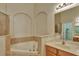 Relaxing bathroom features a soaking tub, vanity, and tiled surround at 11556 Via Lucerna Cir, Windermere, FL 34786