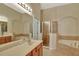 Well-appointed bathroom with a soaking tub, glass-enclosed shower, and spacious vanity at 11556 Via Lucerna Cir, Windermere, FL 34786