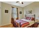 Bright bedroom features a metal bed frame, colorful bedding, and a window with natural light at 11556 Via Lucerna Cir, Windermere, FL 34786