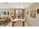 Bright dining area open to the living room, showcasing tile floors and stylish decor at 11556 Via Lucerna Cir, Windermere, FL 34786