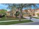 Two-story home boasts manicured lawn, mature trees, and a brick driveway to the attached two-car garage at 11556 Via Lucerna Cir, Windermere, FL 34786