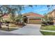 Charming single-story home boasting a tile roof, arched entryway, and well-manicured landscaping at 11556 Via Lucerna Cir, Windermere, FL 34786