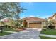 Charming single-story home with a tile roof, brick driveway, and meticulously manicured landscaping at 11556 Via Lucerna Cir, Windermere, FL 34786