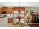 Eat-in kitchen features a glass dining table, floral centerpiece, and pendant lighting at 11556 Via Lucerna Cir, Windermere, FL 34786