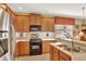 Well-appointed kitchen with stainless steel appliances, wood cabinets, and a convenient double sink at 11556 Via Lucerna Cir, Windermere, FL 34786