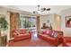 Bright living room features neutral tones, comfortable seating, and large windows at 11556 Via Lucerna Cir, Windermere, FL 34786