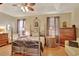 Cozy main bedroom features a four-poster bed, sitting area, and natural light at 11556 Via Lucerna Cir, Windermere, FL 34786