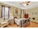 Comfortable main bedroom features a four-poster bed, sitting area, and natural light at 11556 Via Lucerna Cir, Windermere, FL 34786