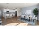 Open-concept dining and kitchen area, perfect for entertaining with wood floors and ample lighting at 13216 Pergola Ave, Orlando, FL 32832