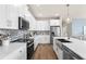 Contemporary kitchen with stainless steel appliances, a central island, and sleek cabinetry at 13216 Pergola Ave, Orlando, FL 32832