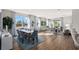 Bright and airy living room with large windows, modern furnishings, and wood flooring at 13216 Pergola Ave, Orlando, FL 32832