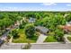An aerial view shows the home's position on a grassy lot and many mature trees surrounding the property at 1632 Oriole Ave, Orlando, FL 32803