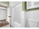Bathroom with a white tile shower, a tub with a curtain, and a toilet, providing a functional space at 1632 Oriole Ave, Orlando, FL 32803
