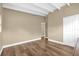 Spacious bedroom featuring hardwood floors, a closet, neutral walls, and a white ceiling with exposed beams at 1632 Oriole Ave, Orlando, FL 32803