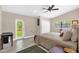 Vaulted ceiling bedroom with neutral tones, ceiling fan, wood-look floors, and backyard views at 1632 Oriole Ave, Orlando, FL 32803