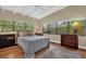 Bedroom with a high ceiling, wooden floors, and a big window for lots of natural light at 1632 Oriole Ave, Orlando, FL 32803
