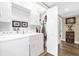 Well-lit laundry room features modern washer, dryer, and ample storage, providing a convenient and organized space at 1632 Oriole Ave, Orlando, FL 32803