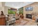 Inviting living room with large windows, neutral decor, and a cozy fireplace, perfect for relaxing and entertaining at 1632 Oriole Ave, Orlando, FL 32803