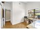 Inviting office features hardwood floors, a large window, custom shelving, and a printer on a small desk at 1632 Oriole Ave, Orlando, FL 32803