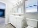 Bright bathroom features a double sink vanity, large mirror, and tile flooring at 1668 Spicewood Ln, Casselberry, FL 32707