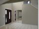 Welcoming entryway with a dark wood front door and mirrored closet doors at 1668 Spicewood Ln, Casselberry, FL 32707