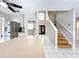 Open-concept design showcasing stainless steel appliances, entryway, and staircase at 1668 Spicewood Ln, Casselberry, FL 32707