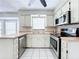 Well-lit kitchen with stainless steel appliances, white cabinets, and a window above the sink at 1668 Spicewood Ln, Casselberry, FL 32707