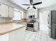 Kitchen featuring stainless steel appliances, white cabinets and a ceiling fan at 1668 Spicewood Ln, Casselberry, FL 32707