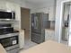 Kitchen featuring stainless steel appliances, light-colored cabinets and tile floor at 1668 Spicewood Ln, Casselberry, FL 32707