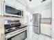 The kitchen features stainless steel appliances and a tiled floor at 1668 Spicewood Ln, Casselberry, FL 32707