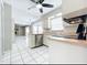 The kitchen features stainless steel appliances and a view into the living room at 1668 Spicewood Ln, Casselberry, FL 32707