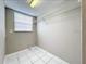 A simple laundry room with a wire rack and white tile floors at 1668 Spicewood Ln, Casselberry, FL 32707
