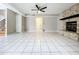Large open living room with stone fireplace and white tile flooring at 1668 Spicewood Ln, Casselberry, FL 32707