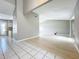 Open-concept living space with white tile and wood flooring at 1668 Spicewood Ln, Casselberry, FL 32707