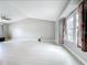 Bright living room featuring a vaulted ceiling, large window, and modern finishes at 1668 Spicewood Ln, Casselberry, FL 32707