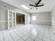Spacious, airy living room with white tiled floors and French doors at 1668 Spicewood Ln, Casselberry, FL 32707