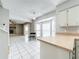 Bright open floor plan boasts white tiled floors and a charming stone fireplace at 1668 Spicewood Ln, Casselberry, FL 32707