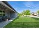 Backyard showcasing a well-manicured lawn and covered patio with seating at 1757 Standing Rock Cir, Oakland, FL 34787
