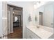 Stylish bathroom featuring a modern vanity and a view into the home's elegant entryway at 1757 Standing Rock Cir, Oakland, FL 34787