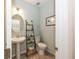 Powder room with pedestal sink, decorative ladder, and tiled floors at 1757 Standing Rock Cir, Oakland, FL 34787