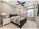 Relaxing bedroom with a decorative mirror and window views, enhanced by neutral paint and a ceiling fan at 1757 Standing Rock Cir, Oakland, FL 34787