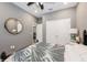 Comfortable bedroom with neutral walls, a ceiling fan, and a round mirror above the bed at 1757 Standing Rock Cir, Oakland, FL 34787