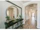 Inviting entryway featuring a stylish console table with a round mirror and decor beneath an arched ceiling hallway at 1757 Standing Rock Cir, Oakland, FL 34787