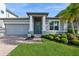 Charming home featuring a brick walkway leading to a covered entry and a well-manicured lawn with lush landscaping at 1757 Standing Rock Cir, Oakland, FL 34787