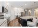Elegant kitchen featuring granite counters, stainless appliances, white cabinets, pendant lighting, and a wine fridge at 1757 Standing Rock Cir, Oakland, FL 34787