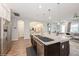Open kitchen featuring granite counters, stainless steel appliances, a central island and a seamless transition to the living area at 1757 Standing Rock Cir, Oakland, FL 34787