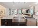 Close-up of a large kitchen island with stainless steel sink and granite countertops, perfect for food prep at 1757 Standing Rock Cir, Oakland, FL 34787