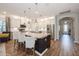 Modern kitchen with white cabinets, stainless steel appliances, granite counters, an island and barstool seating at 1757 Standing Rock Cir, Oakland, FL 34787