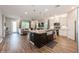 Open concept kitchen with a center island and stainless steel appliances open to the living area at 1757 Standing Rock Cir, Oakland, FL 34787
