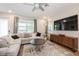 Bright living room with large windows, comfortable seating, and a modern media center at 1757 Standing Rock Cir, Oakland, FL 34787